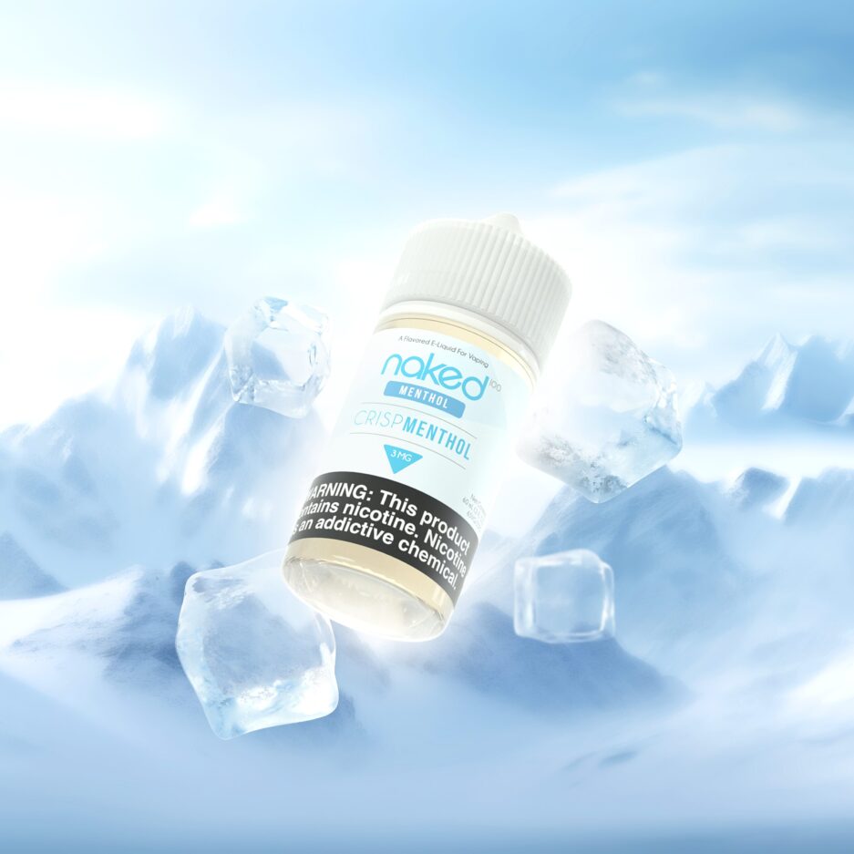 Crisp Menthol is at the center floating next to ice cubes coming form behind the bottle. A bright light behind the bottle creates a glow on the bottle. The setting is in a snowy mountain landscape.