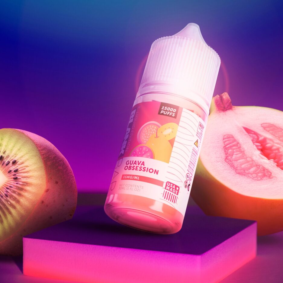 Guava Obsession on a square podium with a kiwi and guava to the sides, in a dark dramatic room lit by bright neon pink and purple lights.