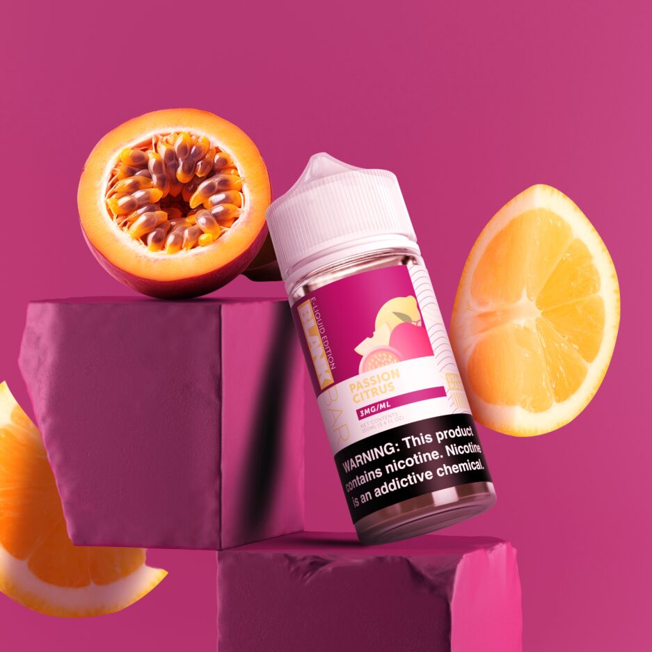 In a full colored burgundy room, Passion Citrus is slanted on two stone like burgundy colored blocks, with a passionfruit on top of one, and lemons flying on the sides of the image.