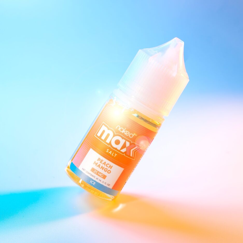 Peach Mango at the center of the image angled upward with a light refraction on the bottle, the floor and bottle are lit from the sides with a neon blue and orange light.