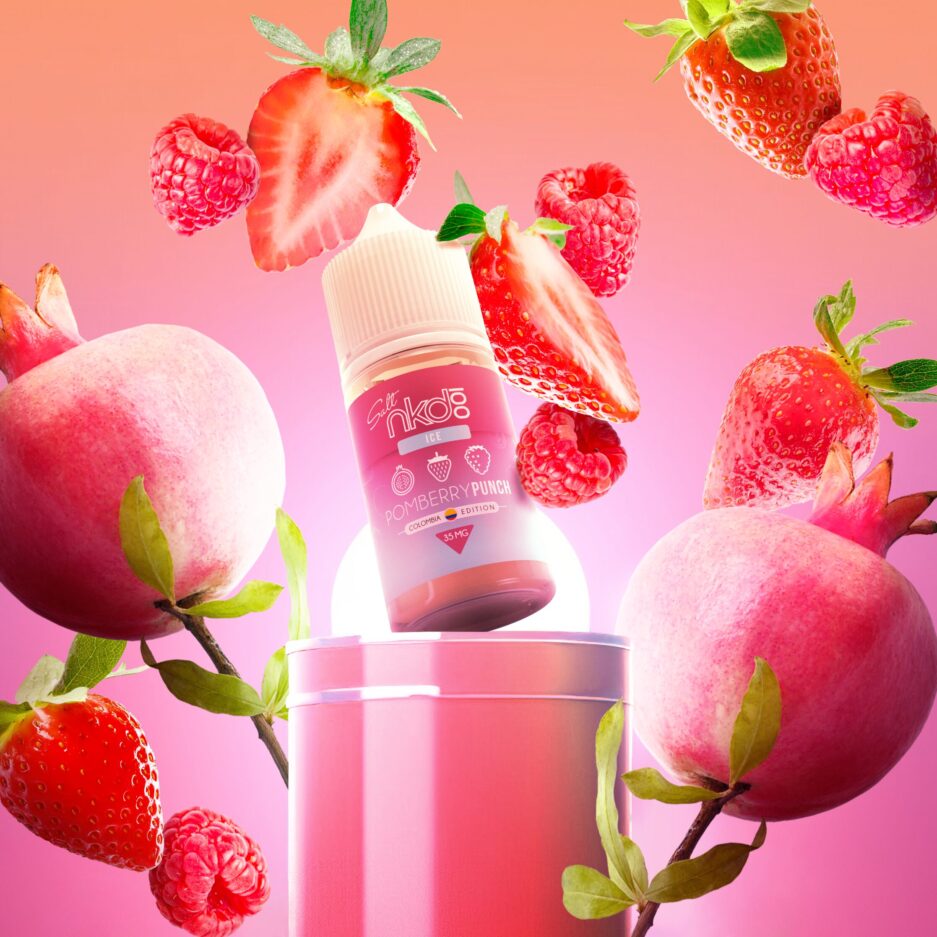 Pom Berry Punch stands angled at the center of the image on a podium with pomegranates, raspberries, and strawberries all flying in different directions, the scene is illuminated by a red sky and a cylinder light source behind the bottle and podium barely in view.