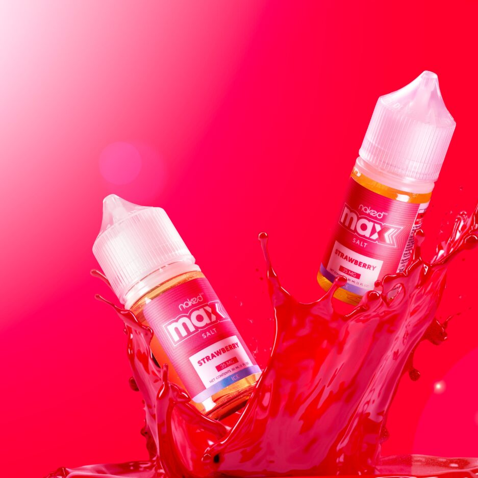 Two bottles of strawberry are rising in the air from a big splash of red liquid, with a vibrant red background.