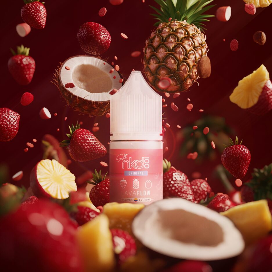 A product shot with burgundy color tones, Coconuts, strawberries, and pineapple slices are piled in the foreground floor of the image. The same fruits are in the background falling to the floor as well. In the center, Naked100 Colombia's Lava Flow stands, illuminated by a light to the right.