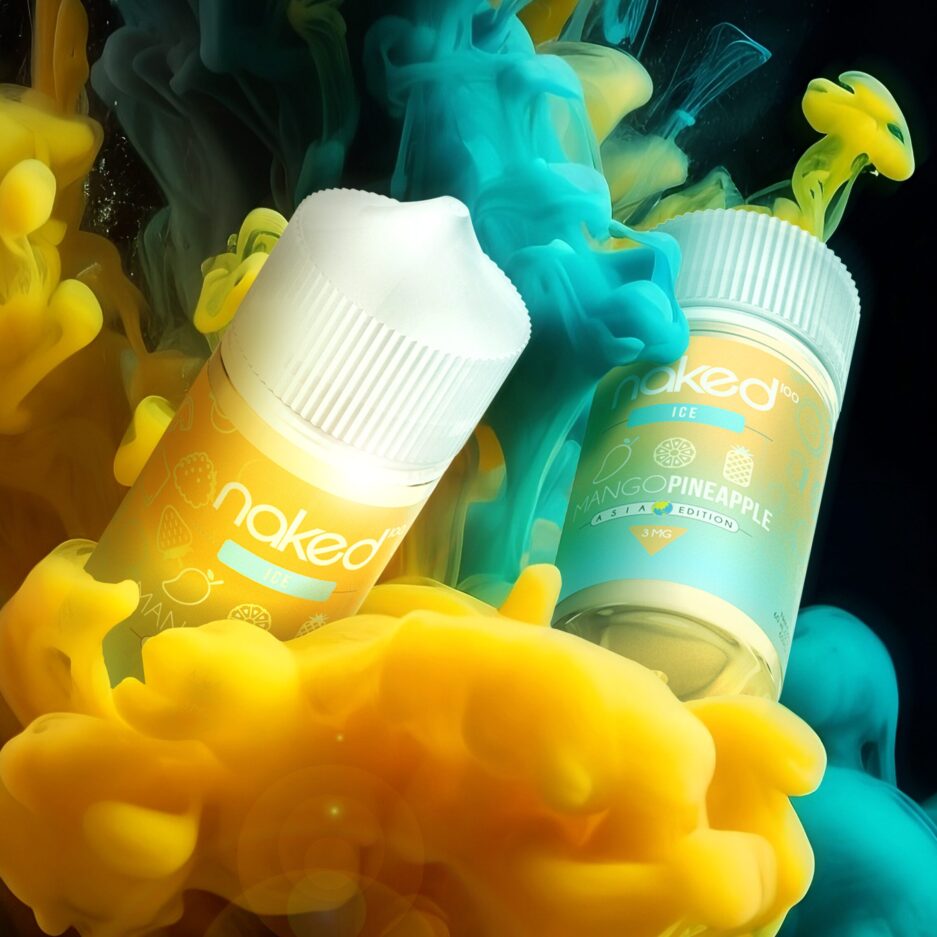 A product shot with a black background and dramatic lighting. Yellow and blue smoke is rising into the shot with two bottles of Naked100's Asia Mango Pineapple are mixed in with the smoke and floating in the air as well.